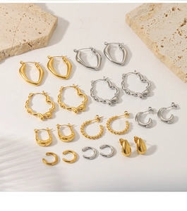 Macro view of gold and silver French vintage earrings on a natural stone base