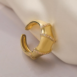 Luxurious 18K gold plated adjustable ring with triple-row zircon stones on soft beige fabric