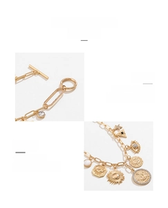 Detailed view of gold celestial charm bracelet with moon and star sun motifs