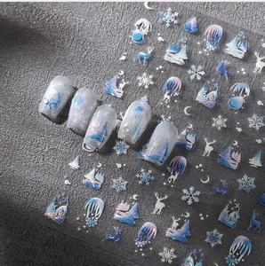 Holographic winter nail stickers with blue snowflakes and reindeer on silver base