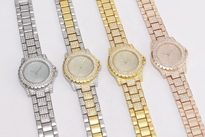 Detail view of quartz watches in silver, gold, and rose gold with crystal encrusted dials