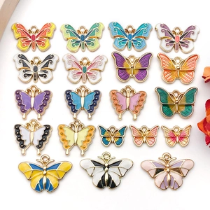 Detailed flat lay of colorful alloy butterfly charms for DIY jewelry and hair accessories