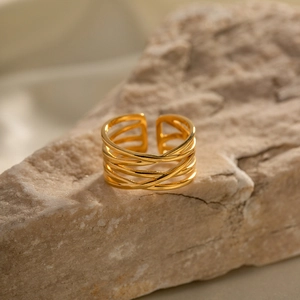18K gold-plated stainless steel woven open ring displayed on a natural stone block