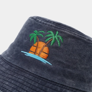 Close-up of coconut tree embroidery and washed cotton texture on vintage bucket hat