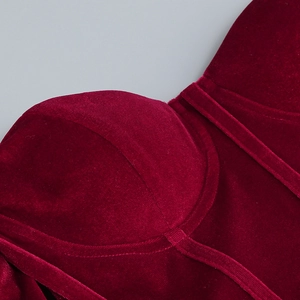 Detail of burgundy velvet dress bodice showing cup structure and vertical stitching