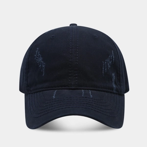 Macro shot of distressed navy blue washed cotton fabric and vintage frayed brim details