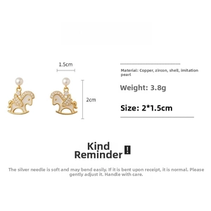 Detailed view of rocking horse earrings with pearls and dimensions 2x1.5cm