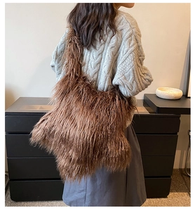 Brown plush crossbody bag on model back with soft faux fur texture and gray outfit
