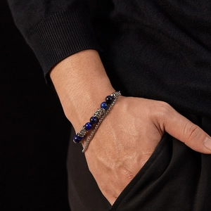 Close-up of double-layer stainless steel chain bracelet with blue tiger eye beads