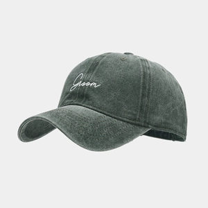 Close-up of Groom embroidery on washed vintage cotton baseball cap with ventilation eyelets