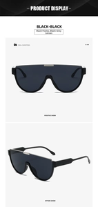 Close-up of oversized shield aviator sunglasses with silver metal top bar and black lenses