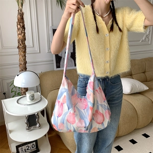 Detail view of pink tulip floral print on large capacity canvas tote bag for commuting