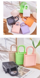 Detailed close-up of colorful PVC jelly mini tote bags with metallic pyramid studs decoration