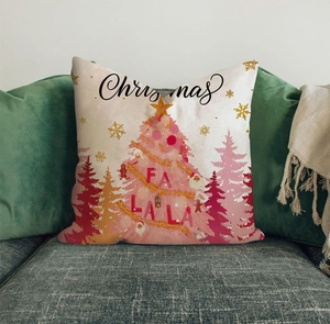 Detailed texture of pink Christmas throw pillow with FA LA LA print on green sofa