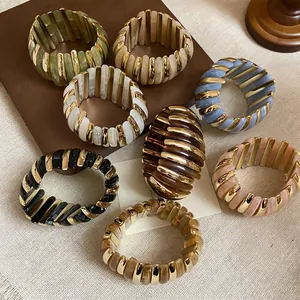 Elastic acrylic beaded bracelets with gold spacers in various marbled colors and textures