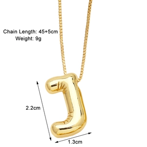 Detail of golden letter J pendant necklace showing dimensions and balloon style texture