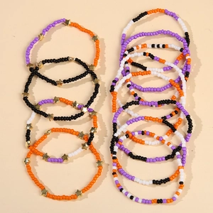Close-up of beaded Halloween bracelet set with stars in orange, purple and black