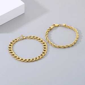 Polished golden curb and rope chain bracelet set for men on minimalist background