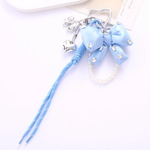 Detail of blue satin bow phone charm with sparkling rhinestones and pearl chain