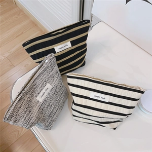 Detailed view of striped cotton makeup bags with zippers and simple wish labels