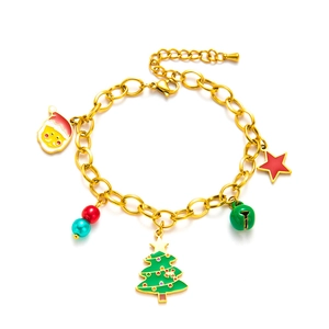 Golden Christmas bracelet with Santa Claus, star, bell and tree charms on white background