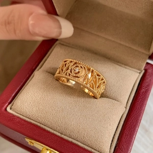 Macro view of 18K gold plated braided ring with a sparkling zircon in a luxury jewelry box