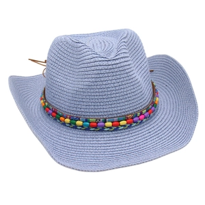 Detail of light blue denim style straw hat featuring colorful beads and boho woven band