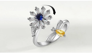 Rotating snowflake ring with bee detail featuring blue and yellow gemstones