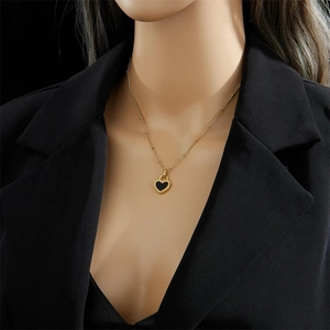18K gold plated heart necklace with black and white pendant on elegant model