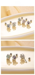 Macro detail of planet-shaped zircon earrings with screw backs in five vibrant colors