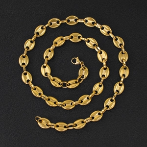 Golden coffee bean chain necklace in pig nose link design on black leather background