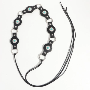 Close-up of black leather belt with turquoise stones and silver flower metal rings