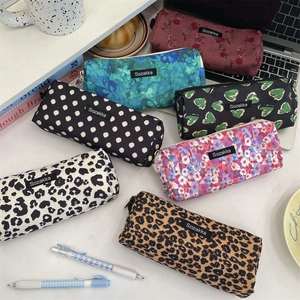 Flat lay of vintage floral and leopard print large capacity corduroy pencil cases