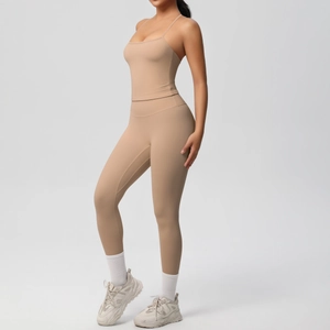 Close-up of nude high-stretch sports bra and leggings set with cross-back detail