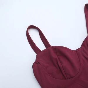 Detail view of wine red lace slip dress showing slim straps and structured V-neck bodice