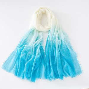 Close-up of soft gradient blue and white cotton linen scarf with elegant fringe detail