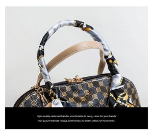 Detail of printed shell bag handle wrapped in decorative silk scarf with gold hardware