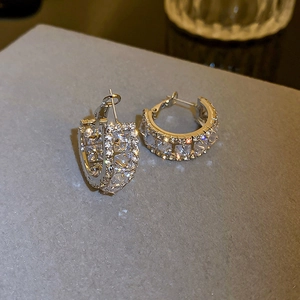 Detailed macro view of silver hoop earrings featuring pavé-set square and round zircons