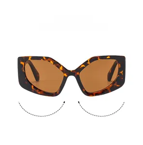Close-up of tortoise shell geometric polygon sunglasses with dark brown lenses