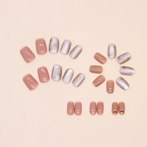 Detailed flat lay of 24pcs cat eye press-on nails with red heart patterns and nude pink finish