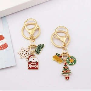 Christmas keychains with gold metal rings featuring Santa, snowflake, and tree charms