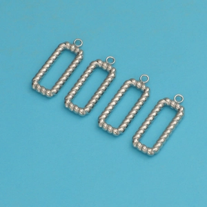 Detailed view of four silver rectangular twisted titanium steel pendant charms on blue background