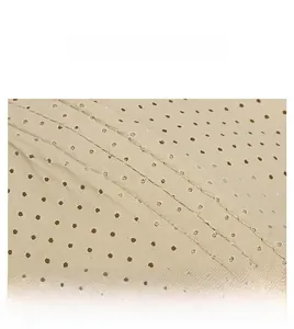 Detail of perforated breathable fabric and reinforced stitching on beige baseball cap