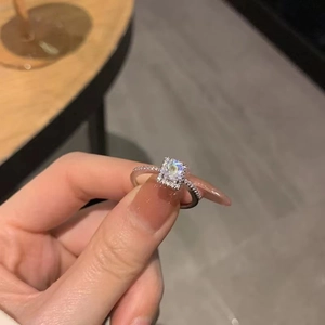 Macro shot of silver ring featuring a rectangular zircon stone with pavé setting detail