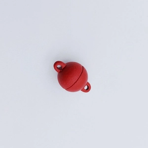 Macro shot of red spherical magnetic jewelry clasps for DIY bracelets and necklaces