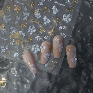 3D floral nail art stickers with white daisies, gold leaves, and pearl accents