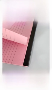 Close-up of pink easy-tear notepad showing top adhesive binding and dotted tearing line