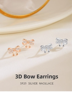 Macro shot of S925 silver bow stud earrings with sparkling cubic zirconia pavé setting