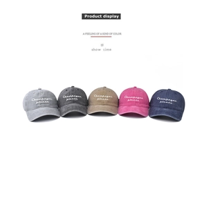 Close-up of five washed cotton baseball caps with Champagne Please embroidery detail