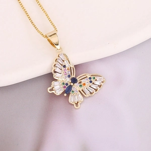 Detail of copper butterfly pendant with colorful zircon stones on gold chain